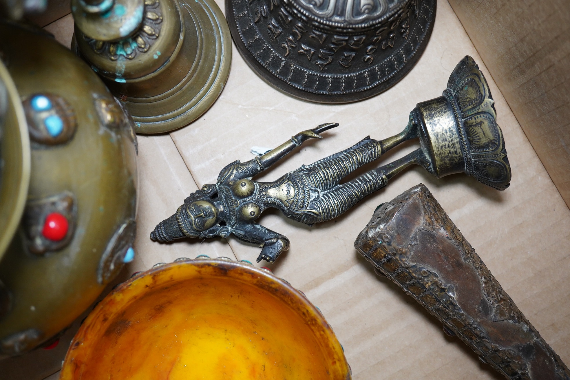 A group of Tibetan brass and mixed metal artefacts to include a brass vase with cabochon inset stones and figures of deities, largest 22cm high. Condition - mostly fair